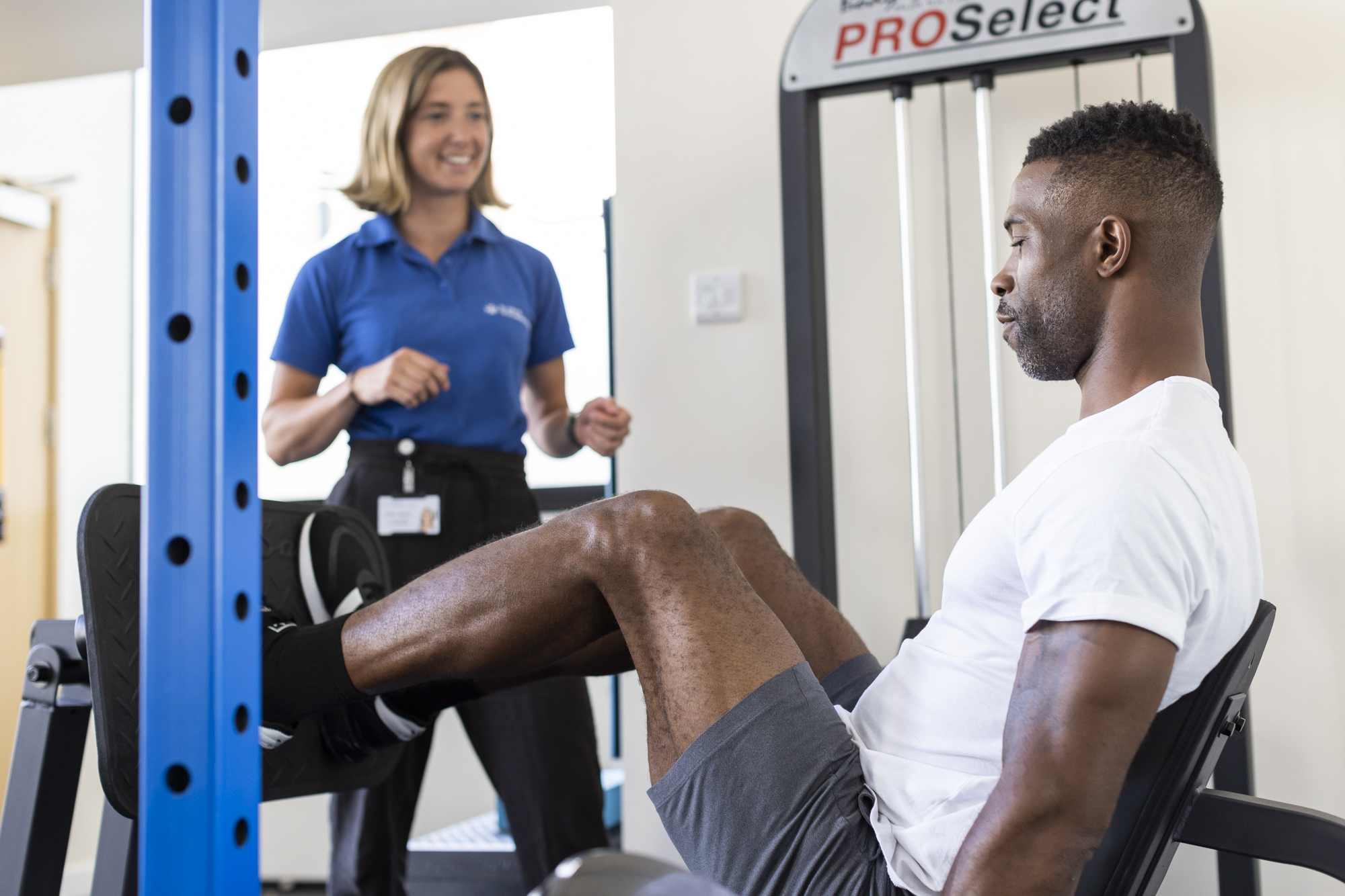 Man using leg push machine to strengthen knee replacement