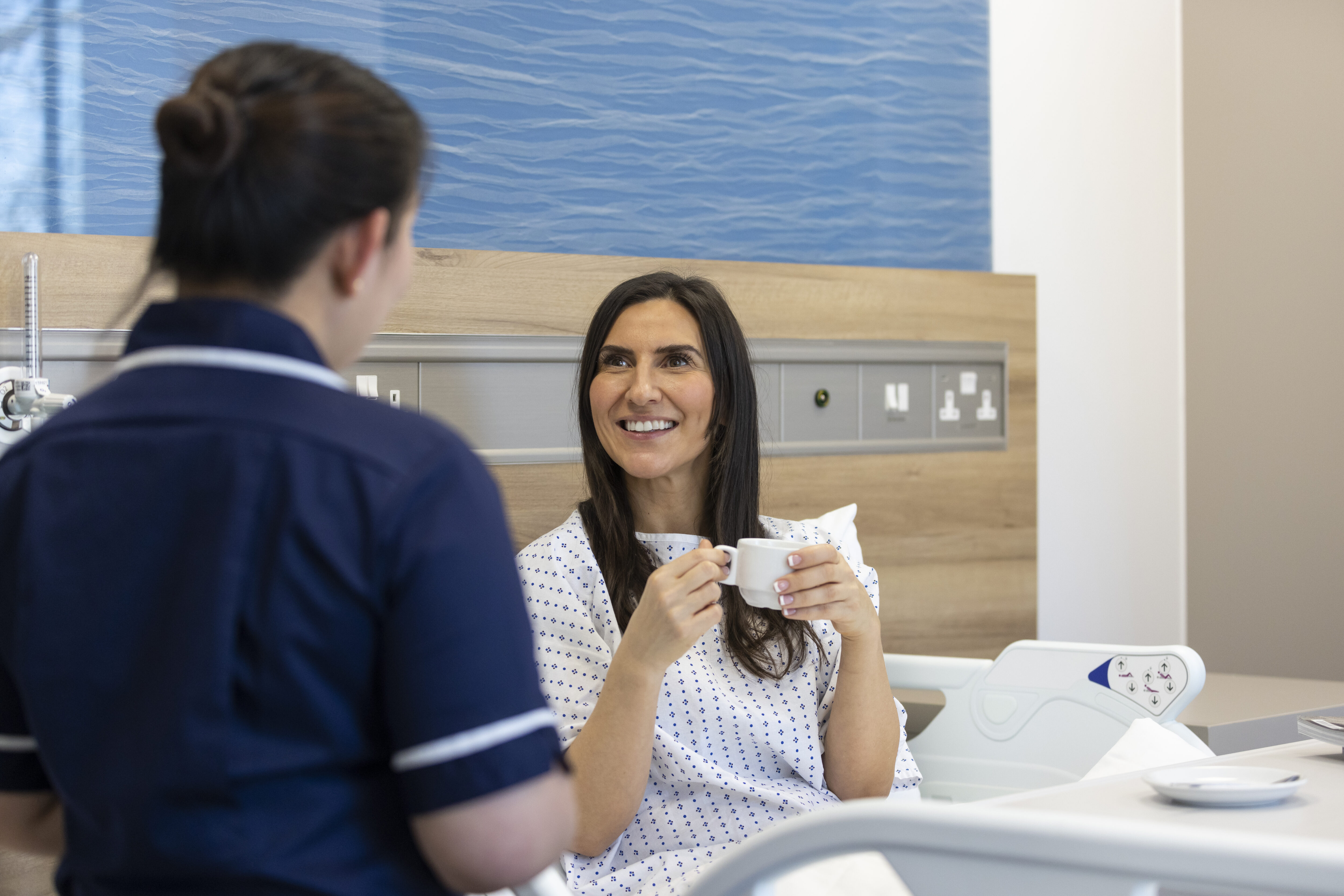 What not to eat after hernia surgery: Patient in bed with cup of tea