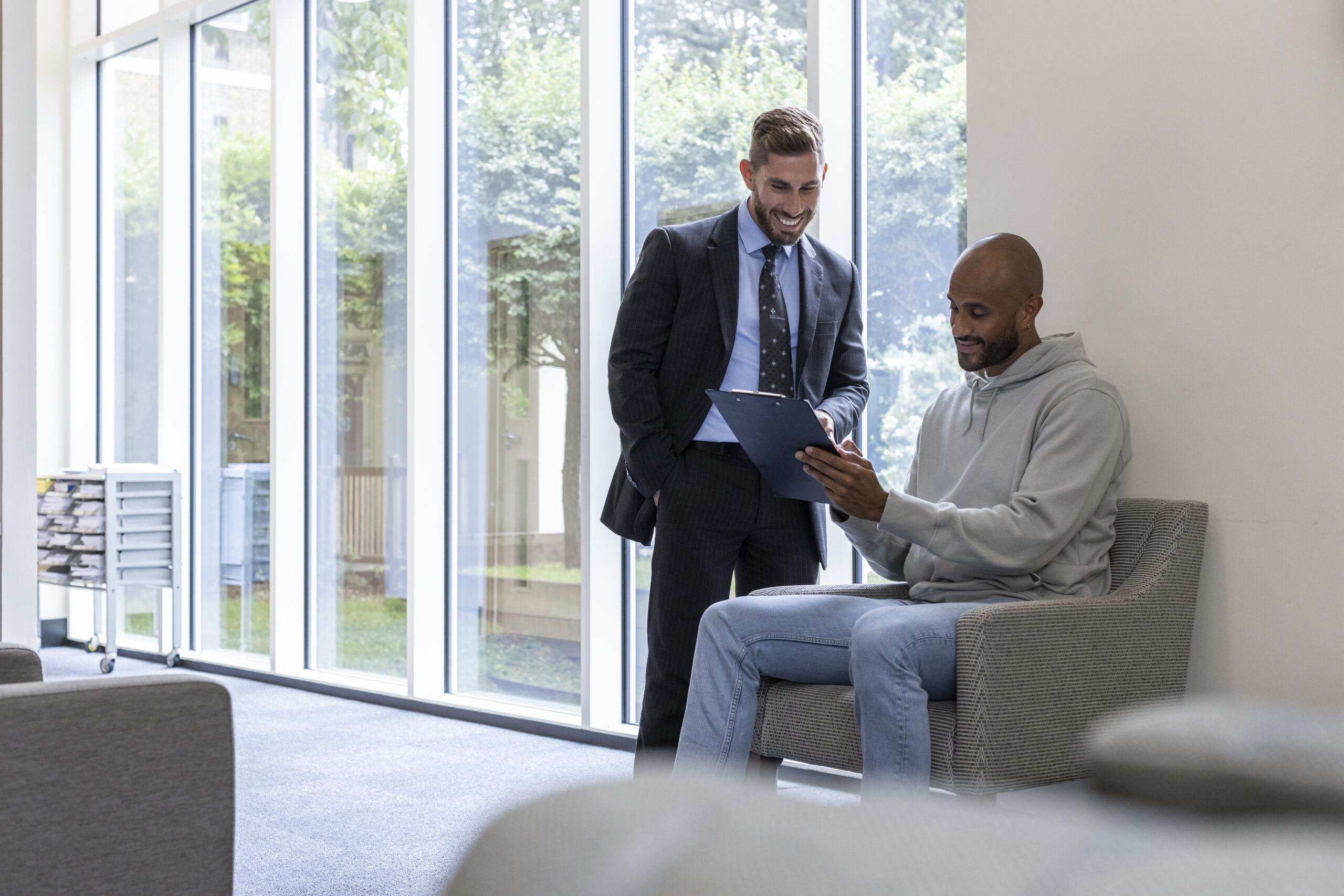 Main at reception of a private hospital paying for private healthcare